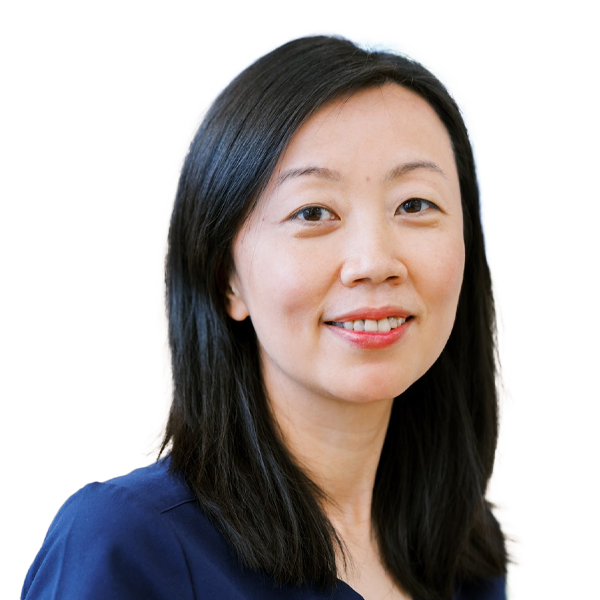 Professional female doctor in navy scrubs smiling warmly at camera against white background