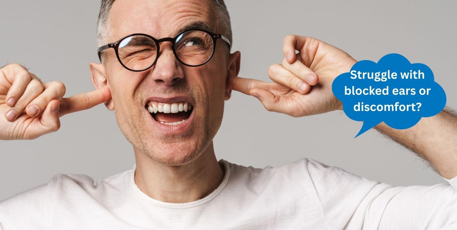 Man plugging his ears with a speech bubble about blocked ears and discomfort
