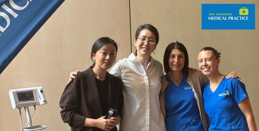 Four healthcare team members smiling together at Madison Medical Practice