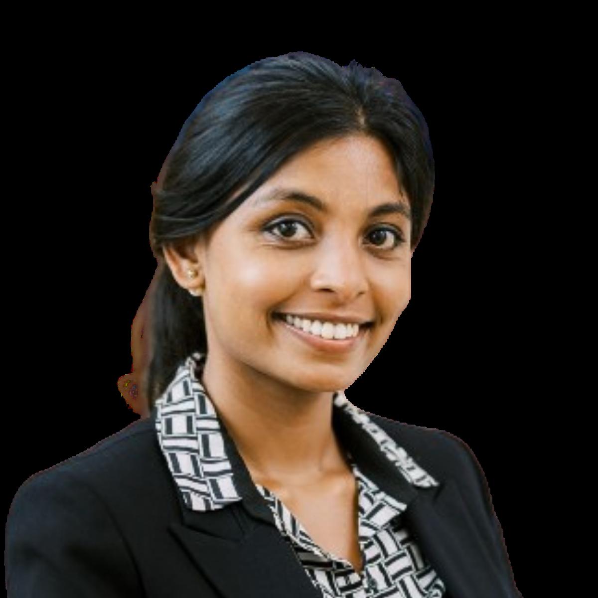 Professional headshot of a smiling female healthcare practitioner in business attire
